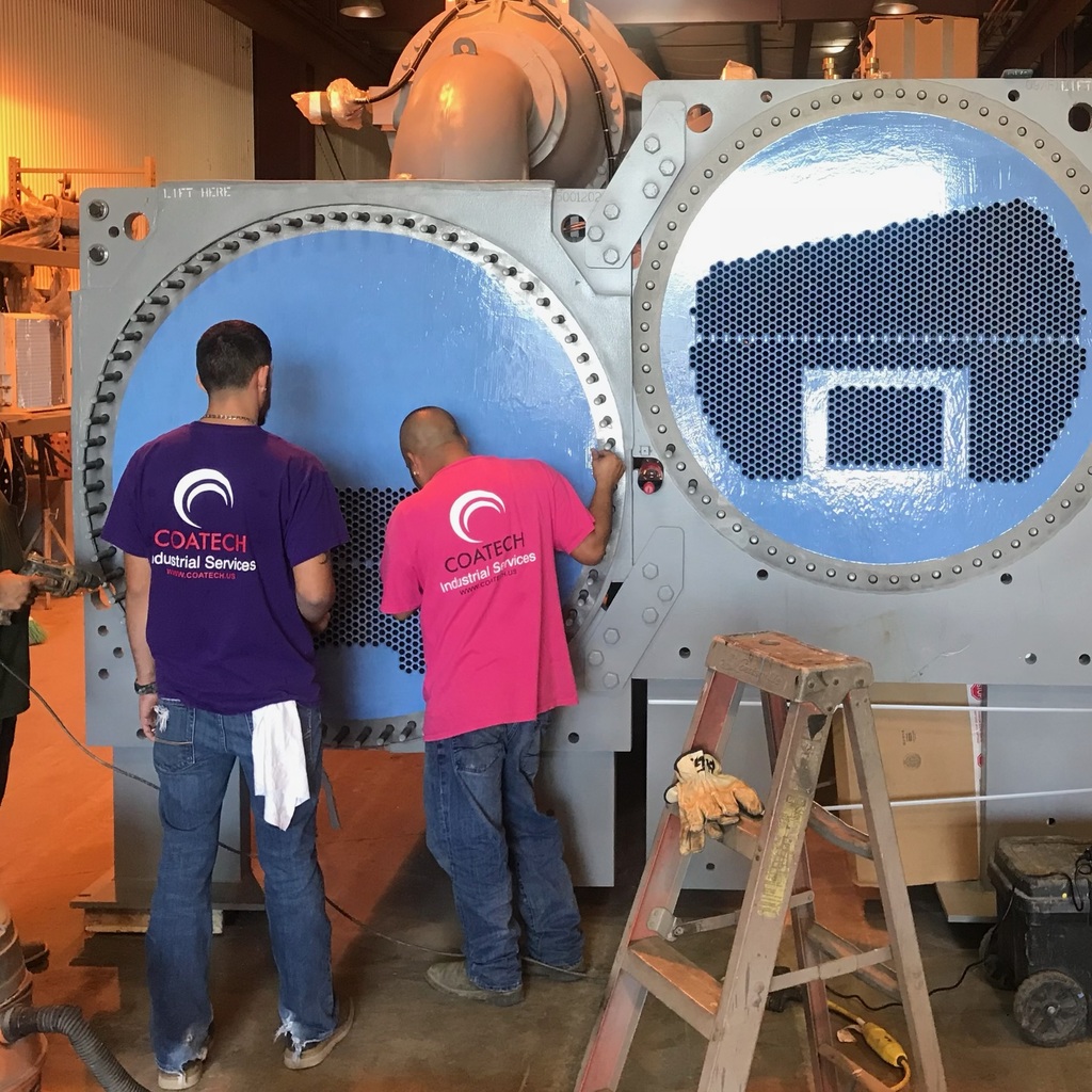 Workers completing an inspection of a heat exchanger after applying industrial coating by Coatech Baton Rouge. 